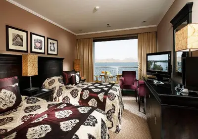 a hotel room with two beds and a flat screen tv at Steigenberger Omar El Khayam Nile Cruise - Every Monday from Aswan for 07 & 04 Nights - Every Friday From Abu Simbel for 03 Nights in Aswan