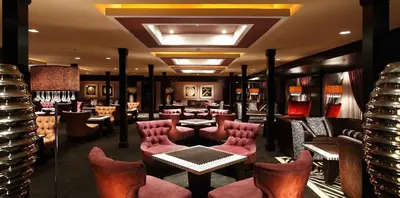 a bar with red chairs and tables in a restaurant at Steigenberger Omar El Khayam Nile Cruise - Every Monday from Aswan for 07 & 04 Nights - Every Friday From Abu Simbel for 03 Nights in Aswan