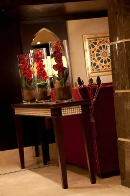 a table with flowers in glass vases on it at Steigenberger Minerva Nile Cruise - Every Thursday from Luxor for 07 & 04 Nights - Every Monday From Aswan for 03 Nights in Luxor