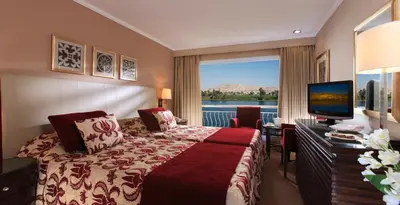 a hotel room with a bed and a television at Steigenberger Minerva Nile Cruise - Every Thursday from Luxor for 07 & 04 Nights - Every Monday From Aswan for 03 Nights in Luxor
