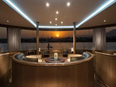 a room with a round table on a boat at Steigenberger Regency Nile Cruise - Every Saturday from Luxor for 07 & 04 Nights - Every Wednesday From Aswan for 03 Nights in Luxor