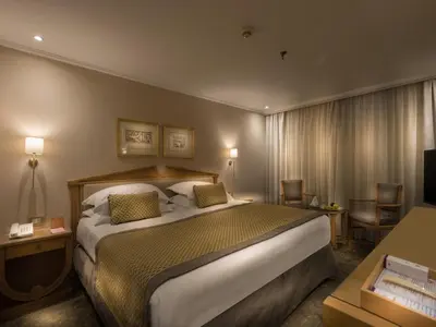 a hotel room with a large bed and a television at Steigenberger Regency Nile Cruise - Every Saturday from Luxor for 07 & 04 Nights - Every Wednesday From Aswan for 03 Nights in Luxor