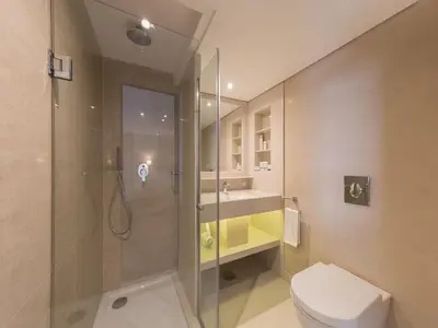 a bathroom with a shower and a toilet and a sink at Steigenberger Regency Nile Cruise - Every Saturday from Luxor for 07 & 04 Nights - Every Wednesday From Aswan for 03 Nights in Luxor