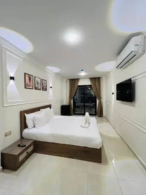 a bedroom with a large bed and a tv at Nile Castle in Luxor