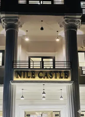 a sign on the door of a white castle at Nile Castle in Luxor