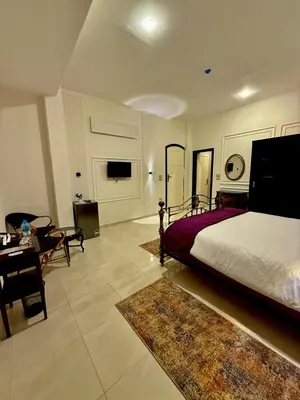 a bedroom with a bed and a living room at Nile Castle in Luxor