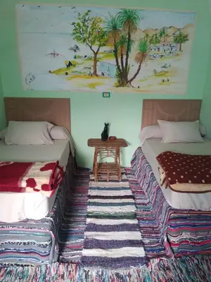 two beds sitting next to each other in a room at Aswan Nubian House in Aswan