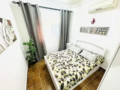 a small bedroom with a bed in front of a window at Karibu House Sheraton Road in Hurghada