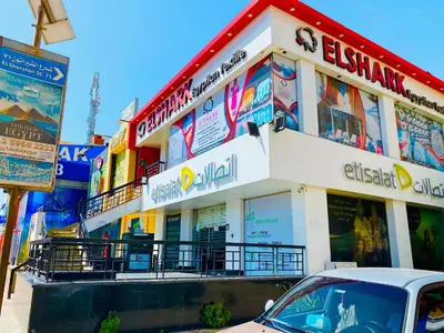 a building with a car parked in front of it at Karibu House Sheraton Road in Hurghada