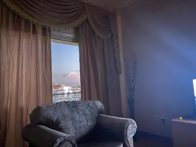 a living room with a chair and a window at Bahga Palace 3 Residential Apartments in Hurghada
