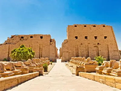 a row of seats in front of two large brick buildings at Nile Cruises 5 Stars From From Aswan 03 Nights -From Luxor 04 Nights in Luxor