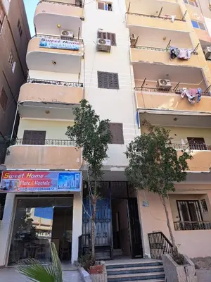 a tall white building with stairs in front of it at Sweet Home Flat 2- 24 Hour open in Hurghada