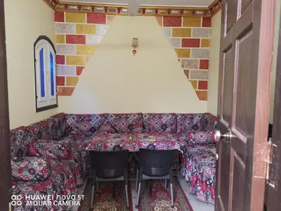 a living room with a couch and two chairs at King Nubian House in Aswan