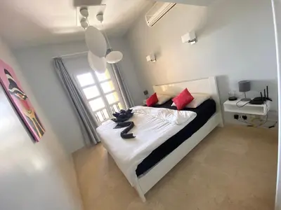 a bedroom with a black cat sitting on a bed at El Gouna Abu Tig Marina OV3550 in Hurghada