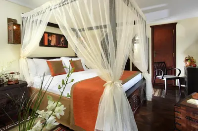 a bedroom with a bed with a canopy at Sonesta Dahabeya Amirat I - Nile Cruise Ship From Luxor to Aswan 7 nights in Luxor