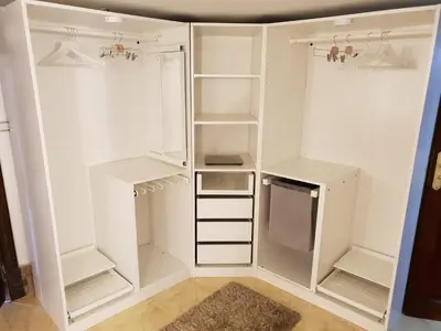 a white closet with white shelves and a refrigerator at One Bedroom Chalet managed by Lilly Homes in Hurghada