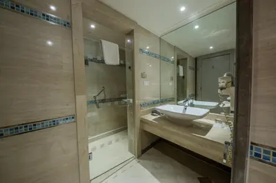 a bathroom with a sink and a mirror at Sunrise Crystal Bay Resort -Grand Select in Hurghada