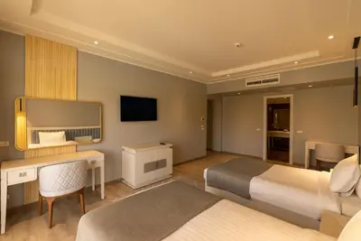 a hotel room with a bed and a desk at Sunrise Crystal Bay Resort -Grand Select in Hurghada