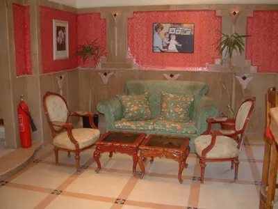 a living room with a couch and two chairs and a table at Diana Hotel Hurghada in Hurghada