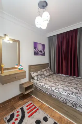 a bedroom with a bed and a mirror at Nubian Village Sky, Hurghada in Hurghada