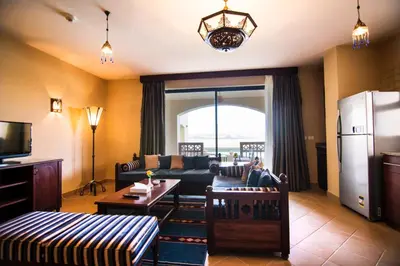 a living room with a couch and a refrigerator at Marina Residence Suites Port Ghalib in Port Ghalib