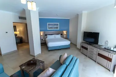 a hotel room with a bed and a couch at Swiss Inn Resort Hurghada in Hurghada