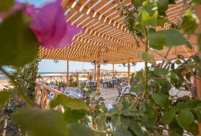 a group of tables and chairs under an umbrella at Hurghada Long Beach Resort in Hurghada