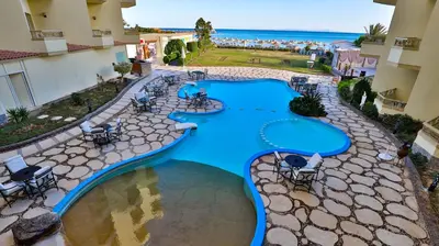 an overhead view of a swimming pool at a resort at Magic Beach Hotel Hurghada in Hurghada