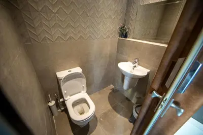 a small bathroom with a toilet and a sink at Anakob in Aswan
