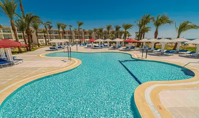 a swimming pool with chairs and umbrellas at a resort at Amarina Abu Soma Resort & Aquapark in Hurghada