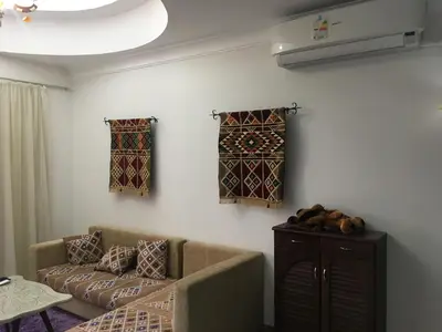 a living room with a couch and some windows at Sea View One Bedroom in Hurghada - H105 in Hurghada