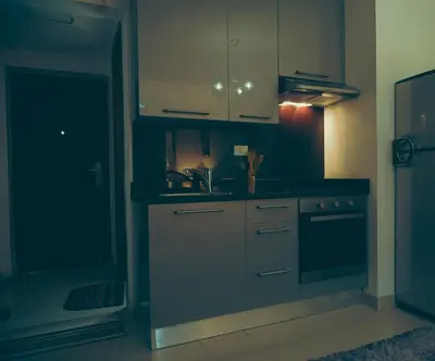 a kitchen with blue cabinets and a sink at Studio at Hurghada- NS2 in Hurghada