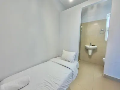 a white room with a bed and a sink at Golden Apartments El Gouna in Hurghada