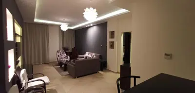 a living room with a couch and a table and chairs at Elite Suites Hurghada in Hurghada