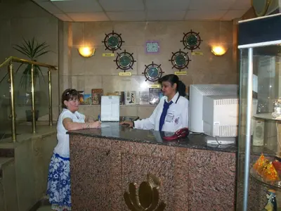 two women standing at a counter in a restaurant at Orchida St. George Hotel in Aswan
