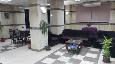 a lobby with couches and a table and chairs at Orchida St. George Hotel in Aswan