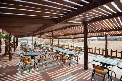 a group of tables and chairs on a deck at Shams Safaga Resort in Hurghada
