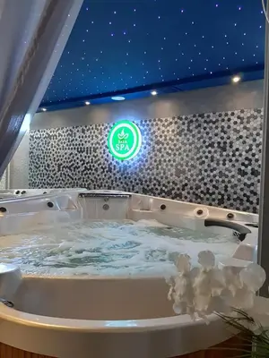 a jacuzzi tub with a sign on a wall at Exoticky apartman in Hurghada