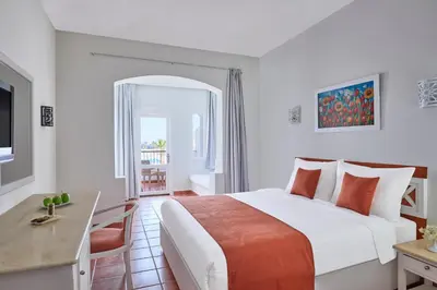 a hotel room with a large bed and a desk at JAZ Neo Reef Marsa in Coraya Bay