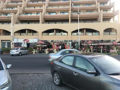 a car parked in front of a large building at Pool View one bedroom at Hurghada - B101 in Hurghada