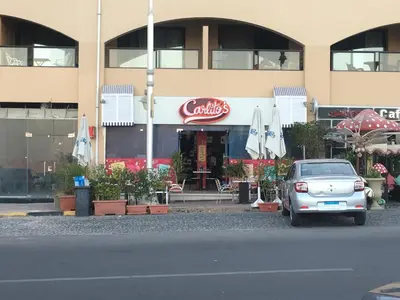 a car parked in front of a building with umbrellas at Pool View one bedroom at Hurghada - B101 in Hurghada