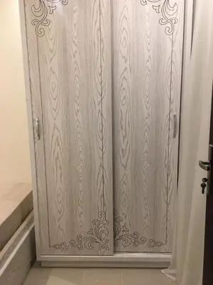 a wooden closet with a wooden door in a room at Pool View one bedroom at Hurghada - B101 in Hurghada