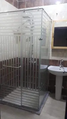 a glass shower in a bathroom with a sink at Villa Misk in Aswan