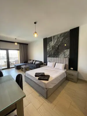 a large bedroom with a bed and a couch at AlDau Heights Apartments in Hurghada