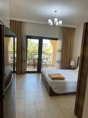 a bedroom with a bed and a balcony at AlDau Heights Apartments in Hurghada