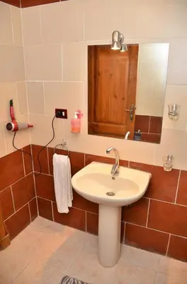 a bathroom with a sink and a mirror at Dolphin Hotel Safaga in Safaga