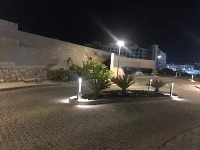 a street at night with palm trees and a street light at Hurghada Furnished Appratment - Al Dau Hights Al Mamsha in Hurghada