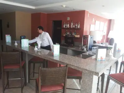 a man standing at a bar in a restaurant at JAZ Neo Ivory in Hurghada