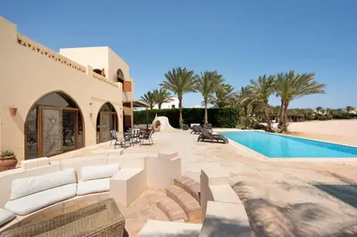 a villa with a swimming pool and a house at VESTA - El Gouna Residence in Hurghada