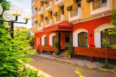 a building on a street in a city at Cleopatra Hotel in Aswan
